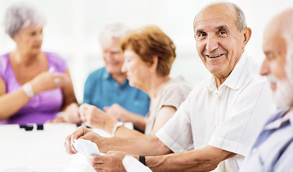 seniors playing cards at retirement community